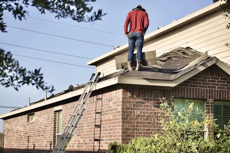 Professional roofer working on a residential roof in Dougherty Street